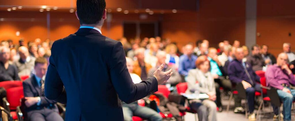 Speaker at a business event with audience