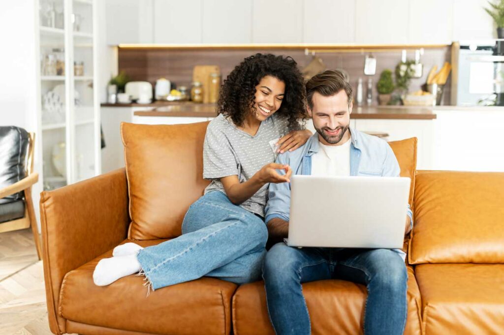 couple viewing a laptop watching video content